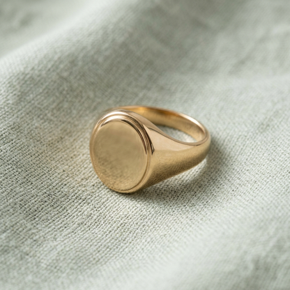 Oval signet ring on pale sage linen