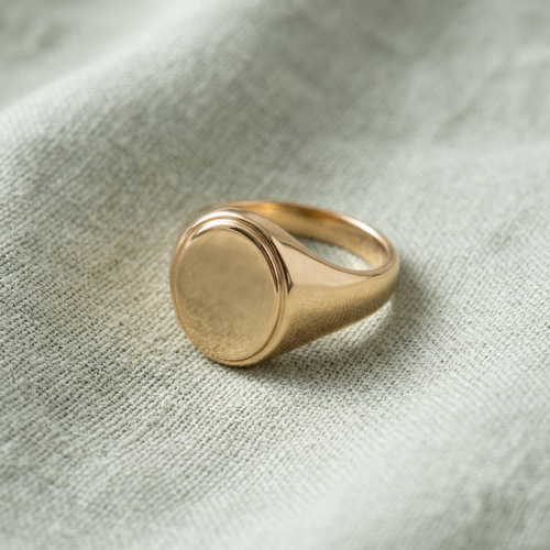 Oval signet ring on pale sage linen