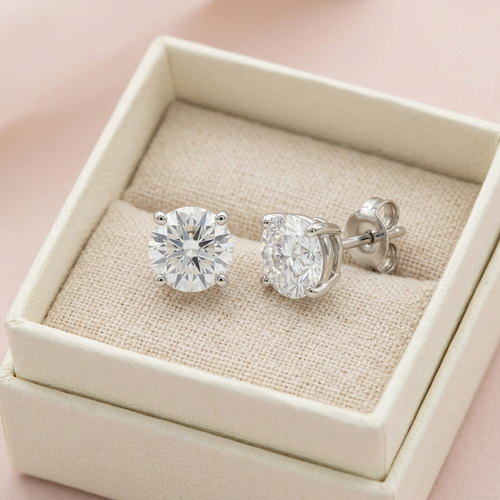Solitaire stud earrings in unbranded ivory box
