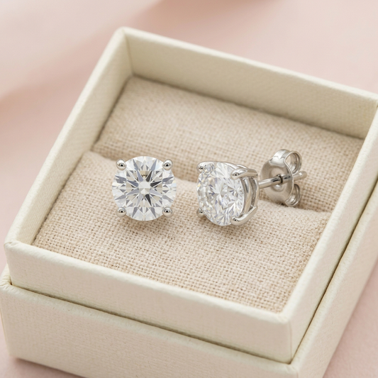 Solitaire stud earrings in unbranded ivory box