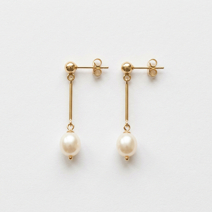 Matching pearl-style drop earrings with gold-tone bars on white