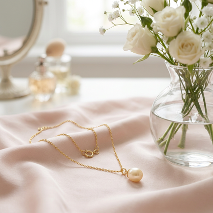 Pearl-style necklace on blush silk with flowers