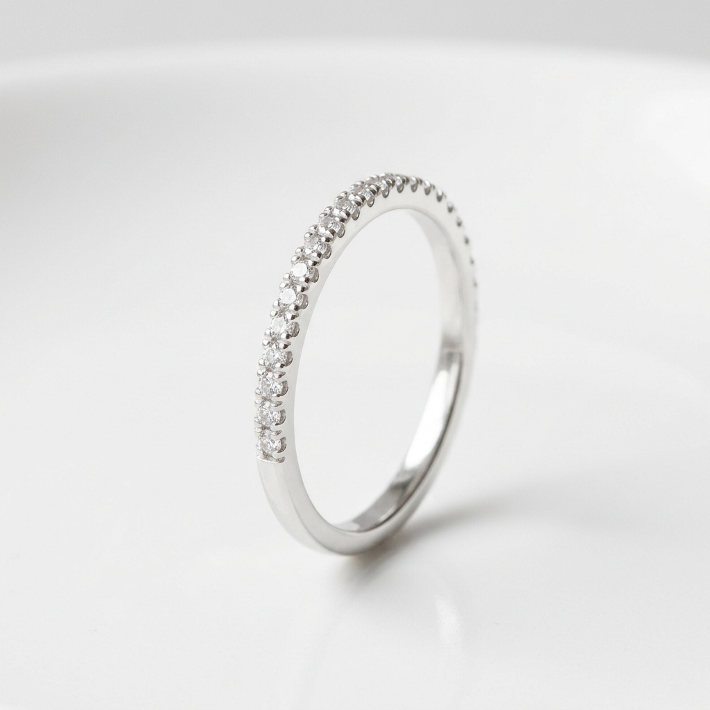 Delicate silver-tone pavé-style band ring on white