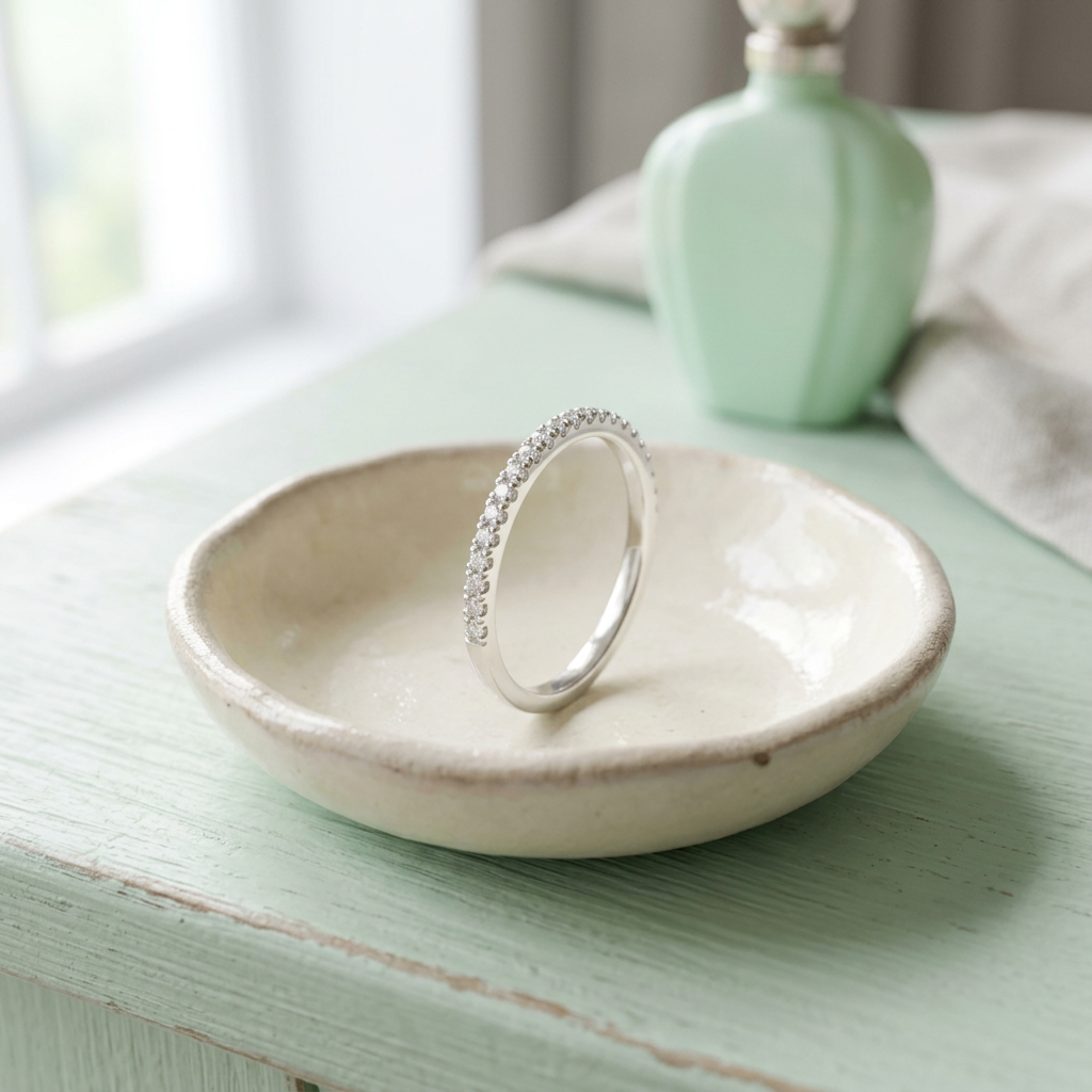 Delicate band ring on ivory ceramic dish
