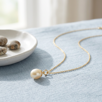 Pearl-style necklace on pale blue linen