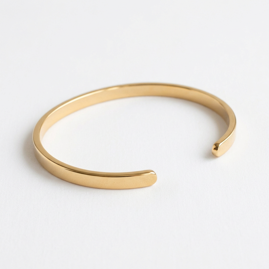 Minimalist smooth gold-tone open cuff on white