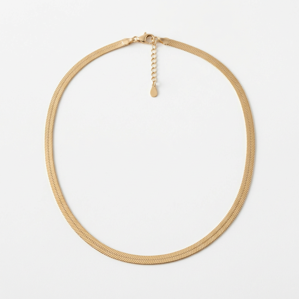 Gold-tone flat herringbone necklace on white