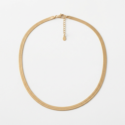 Gold-tone flat herringbone necklace on white