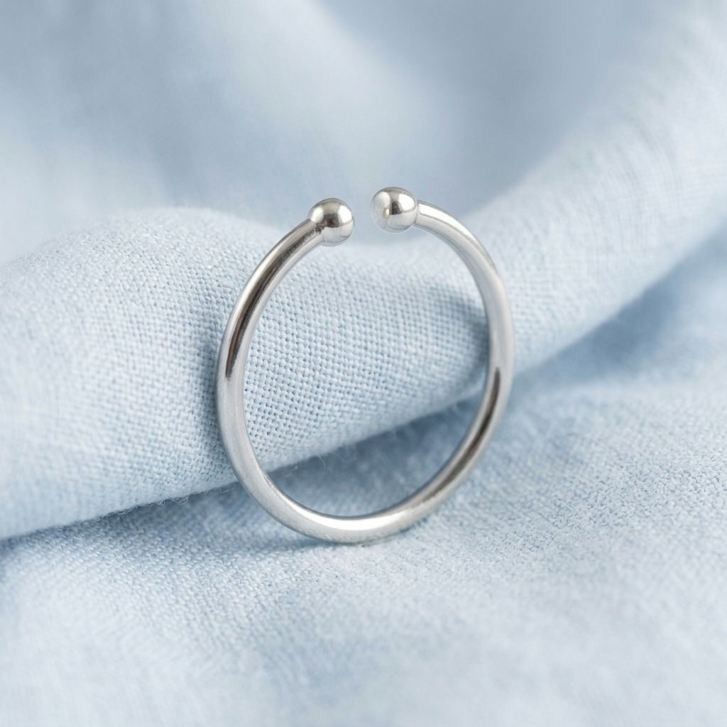 Minimalist open ring on pale blue linen