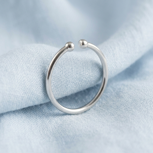 Minimalist open ring on pale blue linen