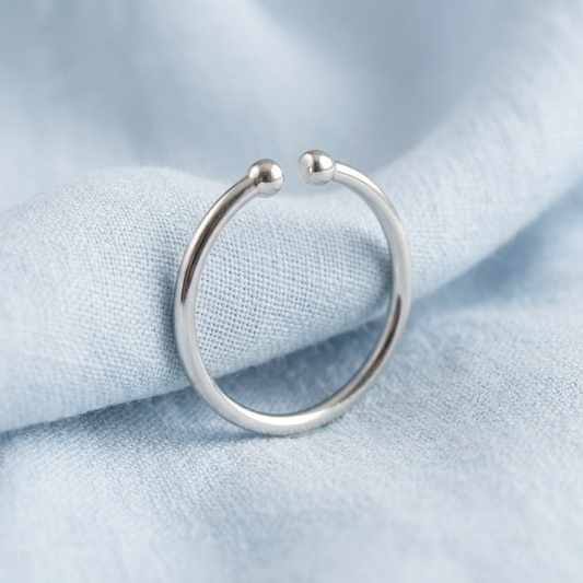 Minimalist open ring on pale blue linen