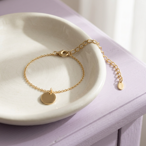 Disc bracelet on ivory ceramic dish