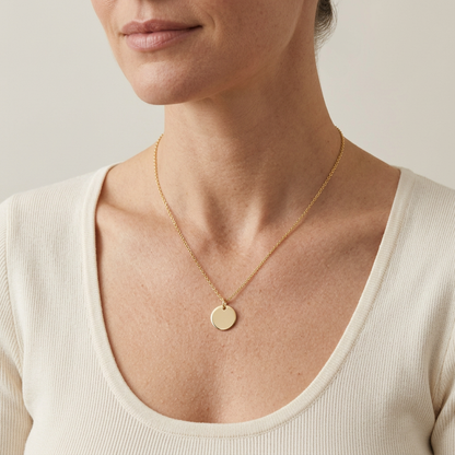 Model wearing gold-tone disc necklace with ivory top