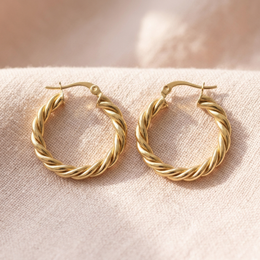 Twisted hoop pair on pale blush linen