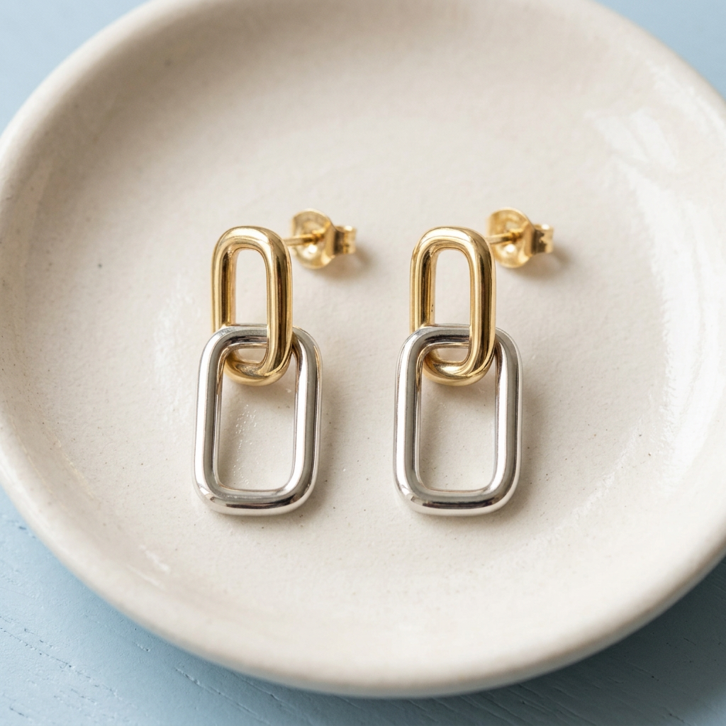 Geometric earrings on ivory ceramic dish