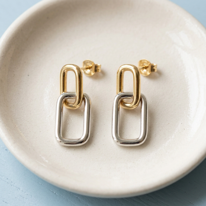 Geometric earrings on ivory ceramic dish