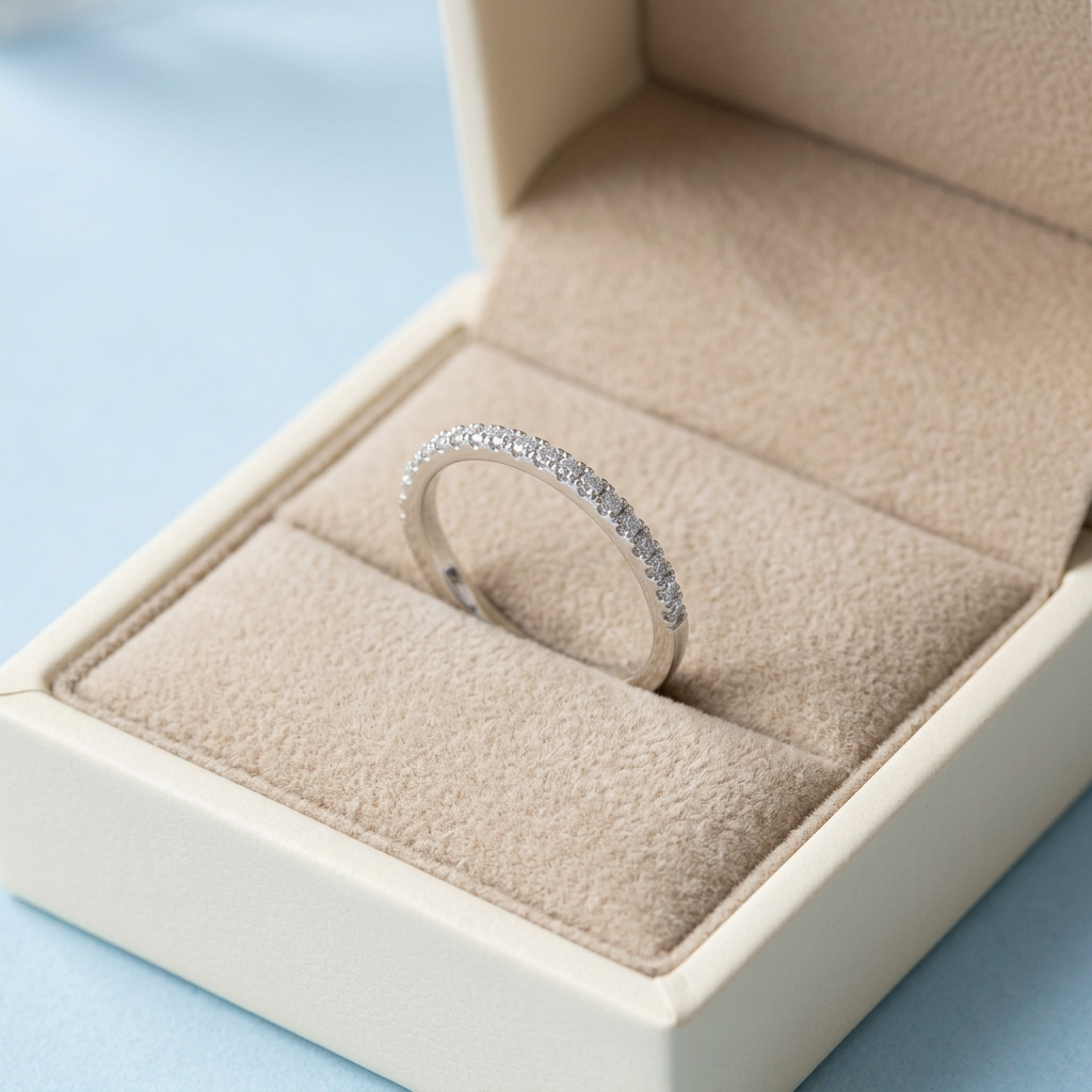 Pavé-style ring in unbranded ivory box