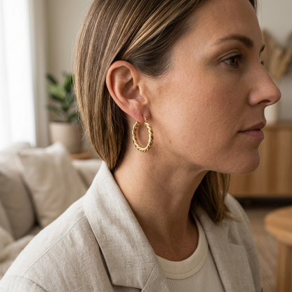 Model wearing twisted hoop earring with beige linen blazer