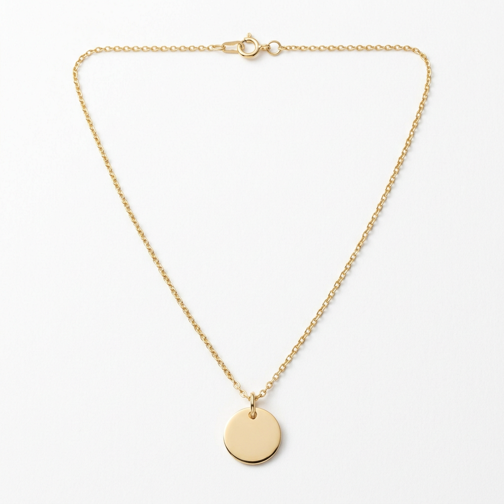 Gold-tone disc pendant necklace on white background