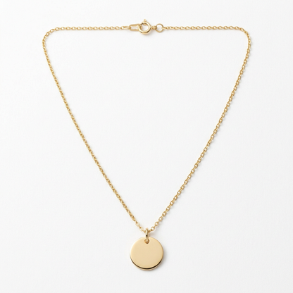 Gold-tone disc pendant necklace on white background
