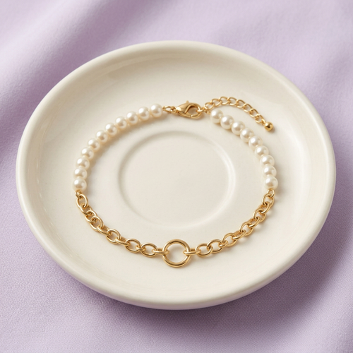 Pearl-style chain bracelet on ivory ceramic dish