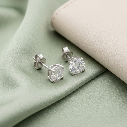 Solitaire studs styled on pale sage satin