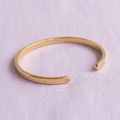 Gold-tone cuff on pale lavender linen