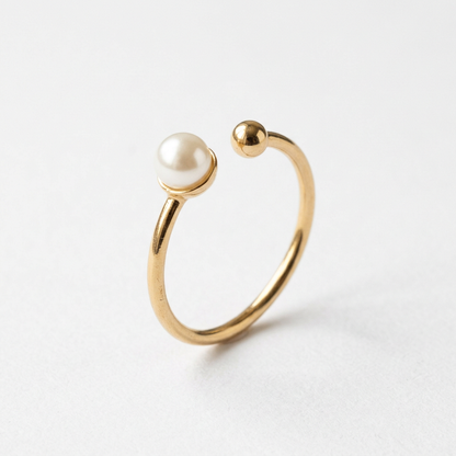 Pearl-style gold-tone open ring on white