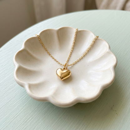 Heart necklace on ivory ceramic dish