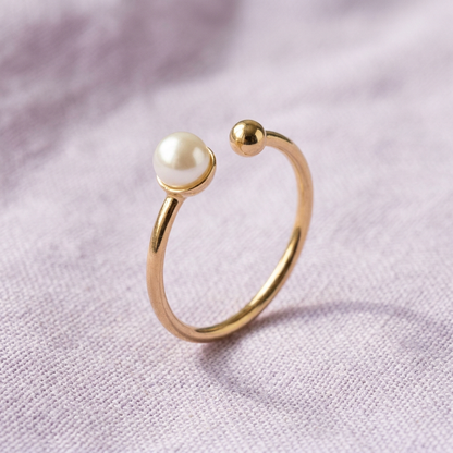 Pearl-style open ring on lavender linen