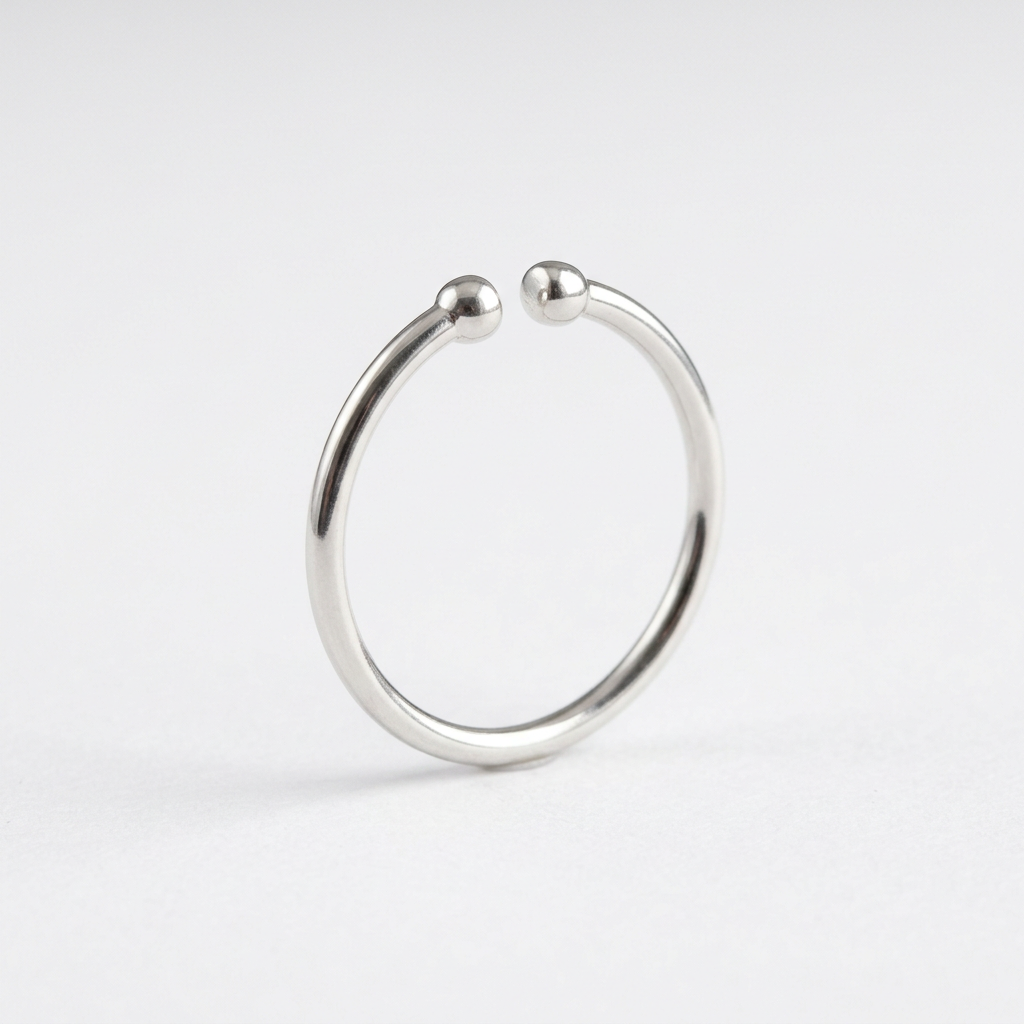 Silver-tone open ring with rounded bead ends on white
