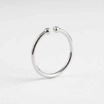 Silver-tone open ring with rounded bead ends on white